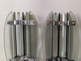 two glass wall sconces on a white wall