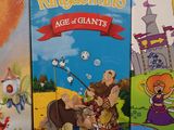 three children ' s board games are lined up on a black surface