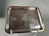 a silver tray on a metal stand on a table