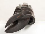 a wooden sculpture of a claw on a white surface