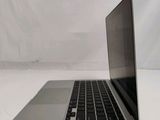 an open laptop computer sitting on top of a white table