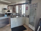 an image of a kitchen with a refrigerator and a refrigerator freezer