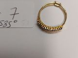 a close up of a gold ring on top of a piece of paper