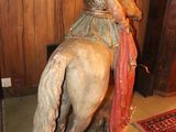 a statue of a man riding a horse in a room