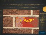 a picture of a brick wall with a yellow dot on it