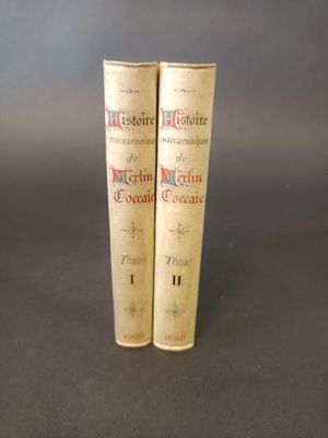two old books sitting on top of a table next to each other