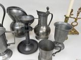 a lot of silver vases and cups on the table