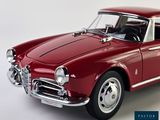 an image of a red model car on a white background