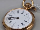 a gold pocket watch with roman numerals on it