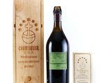 a bottle of wine in front of a wooden box