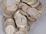 a pile of silver coins sitting on a table