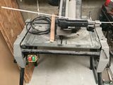 a table with a saw on it in a garage