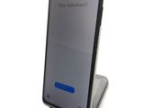 the back of a black samsung s9 phone with a blue button on it