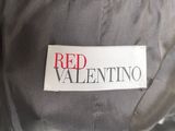 the label on the back of a jacket reads red valentino