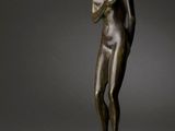 an image of a bronze statue of a man holding a book