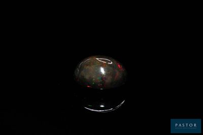 an image of a black oplite sphere in the dark