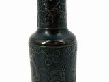 a black vase with a design on it on a white background