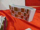 a bowl and a plate on a table with a red cloth