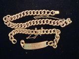 a gold chain with a name tag attached to it