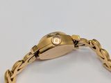 an image of a close up of a gold watch on a white surface