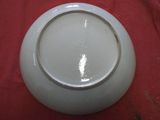 a white bowl sitting on a red table cloth