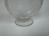 a glass vase that is sitting on a table