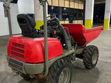 a small red tractor parked in a garage