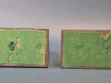 pair of green and brown ceramic cufflinks with holes in them