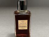 a close up of a bottle of perfume on a table
