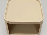 an image of a beige plastic box with a shelf on it