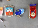 several different types of badges are displayed on a gray surface