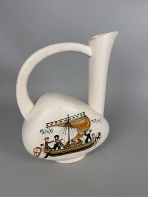 a white vase with a picture of a boat on it