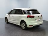 the rear end of a white citrole parked in a room