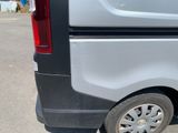a white van with a flat tire parked in a parking lot