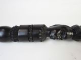 an image of a black cane with skulls and acorns