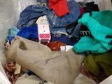a bag full of clothes that is sitting on the floor