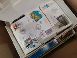 a box with a lot of stamps and a pen in it