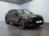 a black audi suv parked in a garage with a white wall