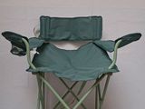 a green folding chair that is sitting on a white floor