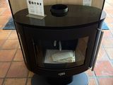 a black stove sitting on a tiled floor in a room