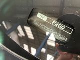 a close up of a person ' s hand holding a car ' s rear view mirror