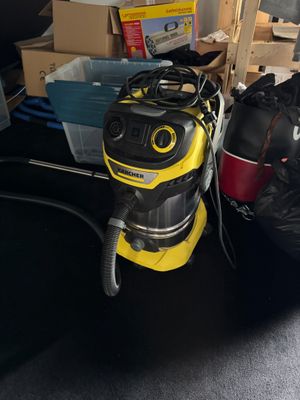 a yellow vacuum cleaner sitting on the floor next to a pile of boxes