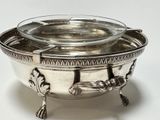 a silver bowl with a lid on a white surface