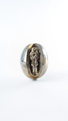 a close up of a silver ring with a jesus on it
