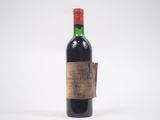 une vieille bouteille de vin rouge avec une étiquette dessus