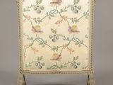 an ornately decorated fireplace screen with birds and flowers on it
