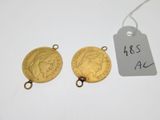 two gold coins with a price tag on top of them