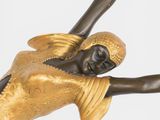 statue of a woman holding a tennis racquet in her right hand