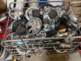 a metal basket filled with assorted items in a garage