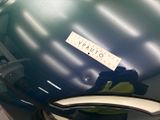 a blue suitcase with a sticker on it sitting on a table